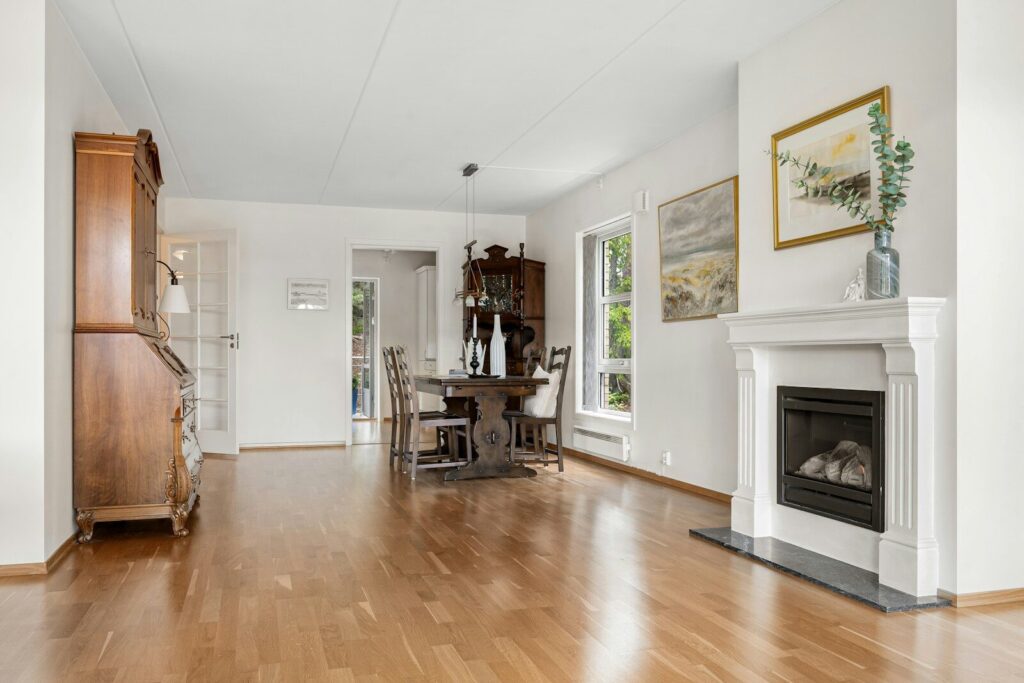 A living room with a fire place and hardwood floors