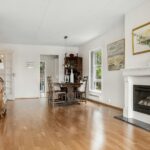 A living room with a fire place and hardwood floors