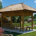Wooden gazebo with seating in a sunny garden